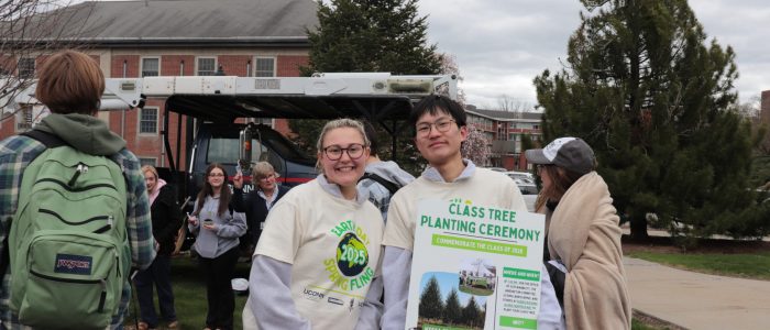 Two student coordinators, Amanda McCard and Andy Zhang for the Class Tree planting pose with Class Tree Poster
